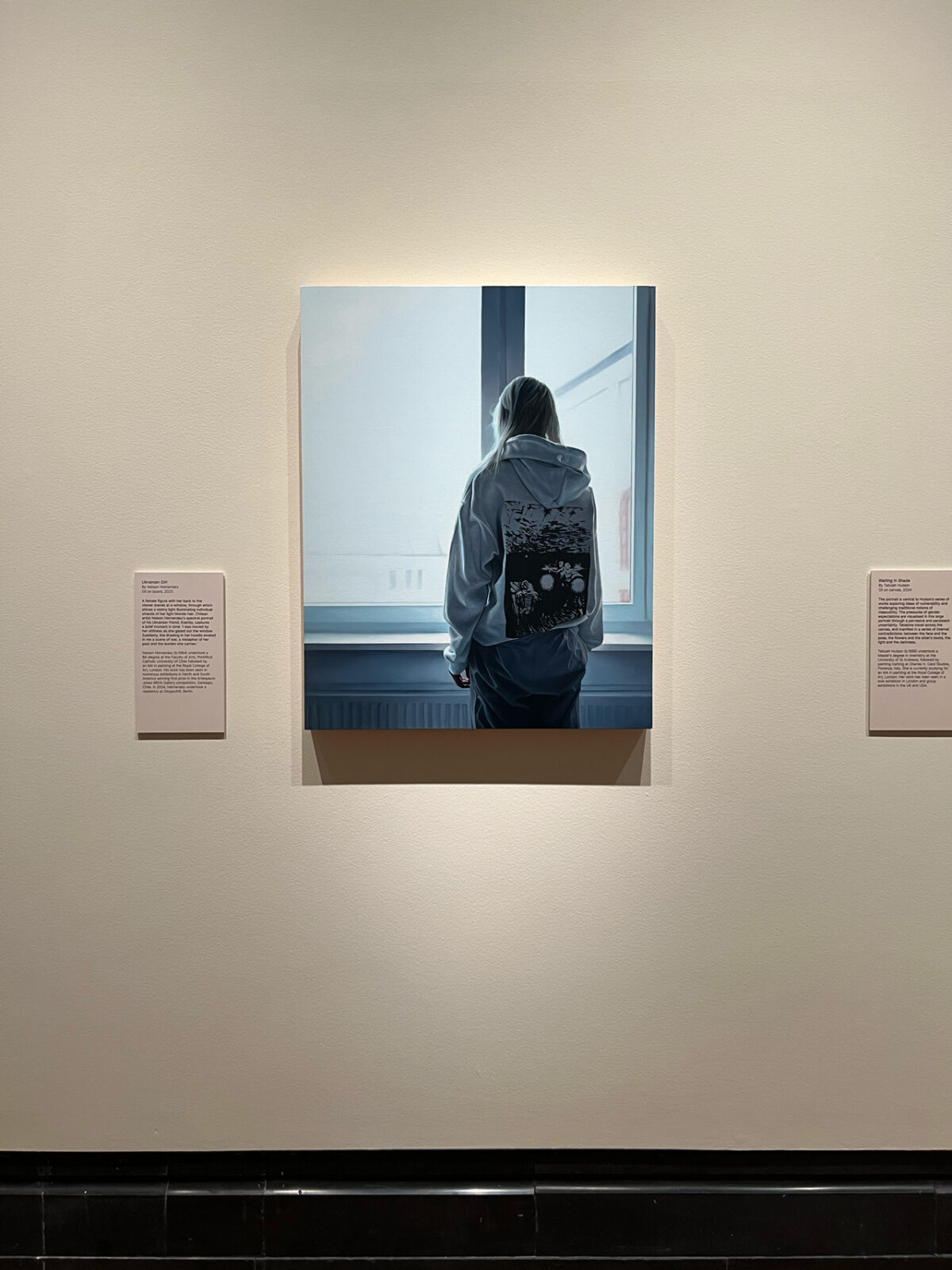 Ukranian girl expuesta en la Portrait Gallery como parte de la muestra Herbert Smith Freehills Portrait Award 2025, con placas de texto curatorial a ambos lados