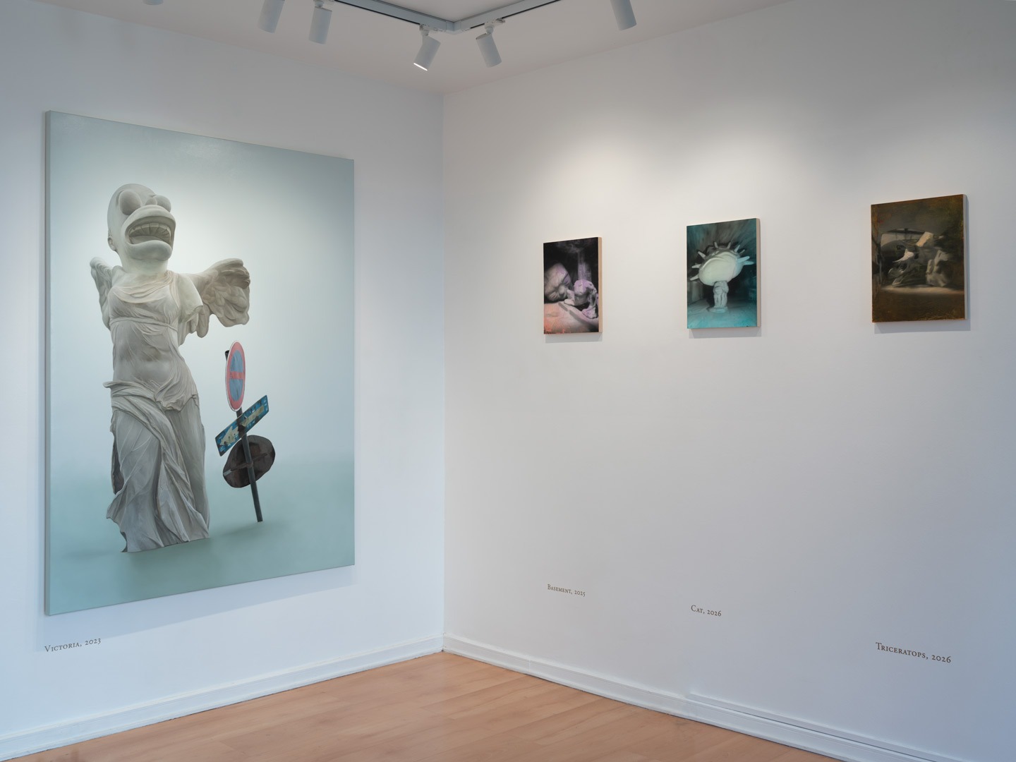 Corner view of the main gallery showing Victoria (2023) on the left and three smaller paintings — Basement, Cat, and Triceratops — on the adjacent wall